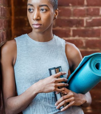 Close-up of a yoga mat corner and a water bottle.